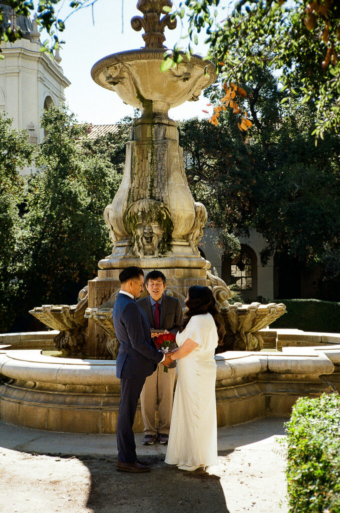 Film photo of a couple holding hands during their Pasadena City Hall elopement ceremony.