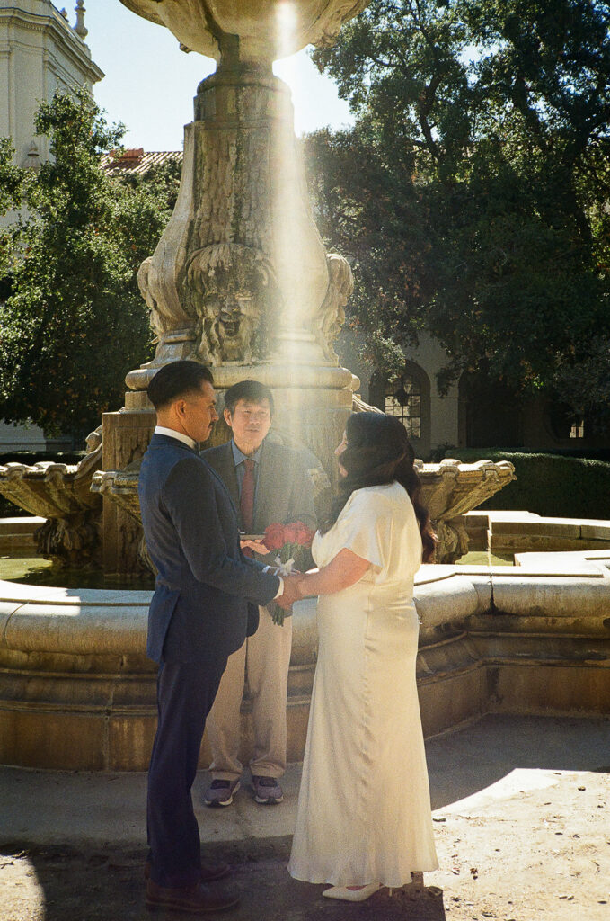Film photo of a couple holding hands during their Pasadena City Hall elopement ceremony.