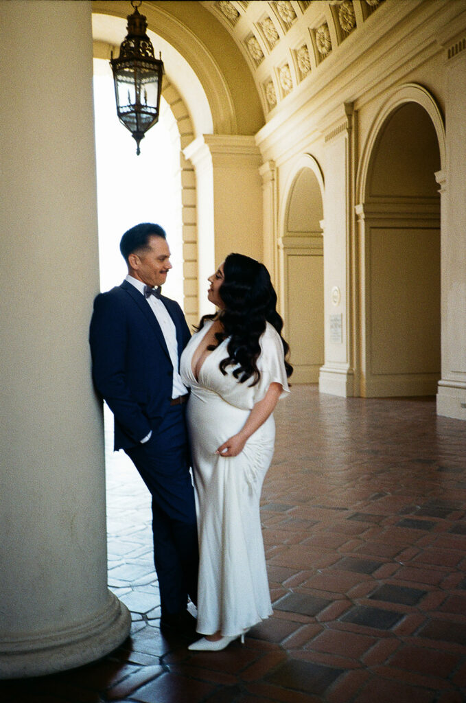 Bride and groom smiling at one another during their film elopement photos. 
