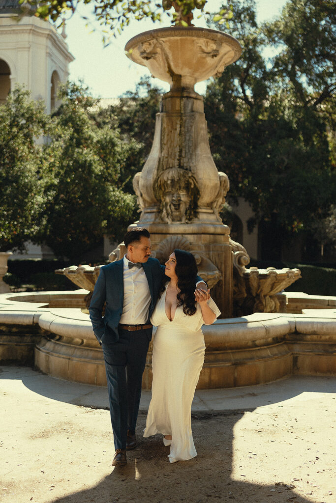 Couple posing in front of the fountain at Pasadena City Hall.