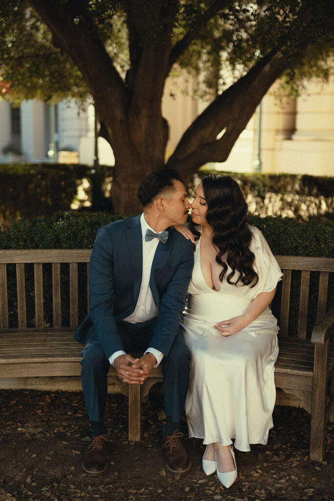 Couple sitting on a bench in the courtyard at Pasadena City Hall.