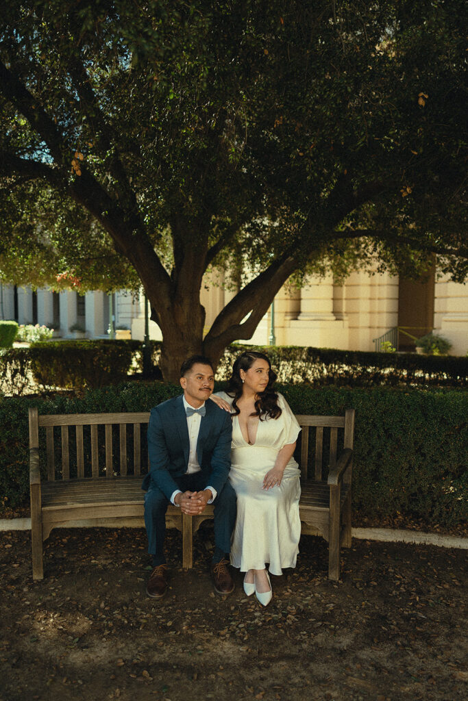 Couple sitting on a bench in the courtyard at Pasadena City Hall.