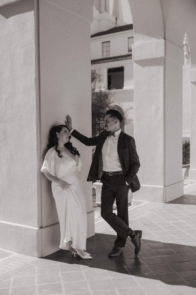 Black and white editorial photo of a couple posing at the Pasadena City Hall.