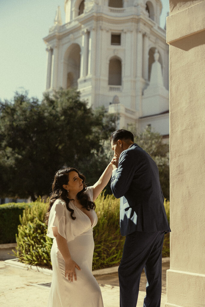 Man kissing his brides hand during their Pasadena City Hall elopement.
