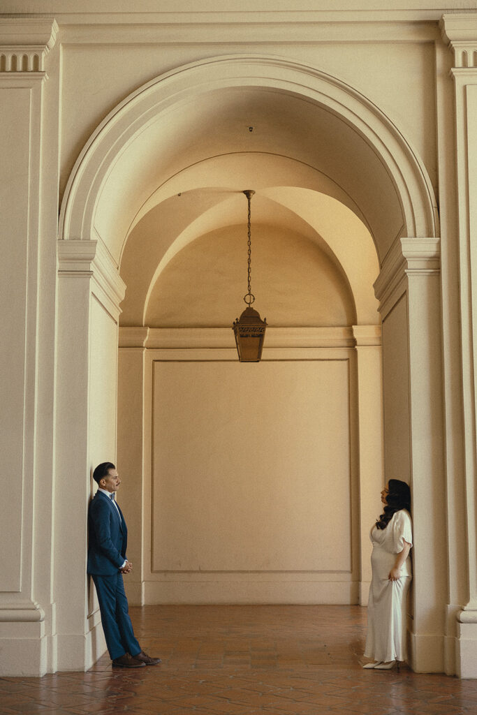 Couple standing across from one another at the Pasadena City Hall.