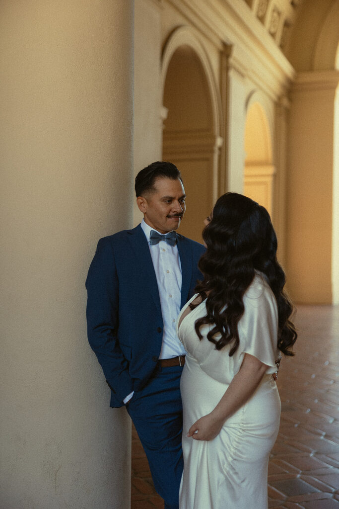 Couple smiling at one another for their city hall elopement photos.