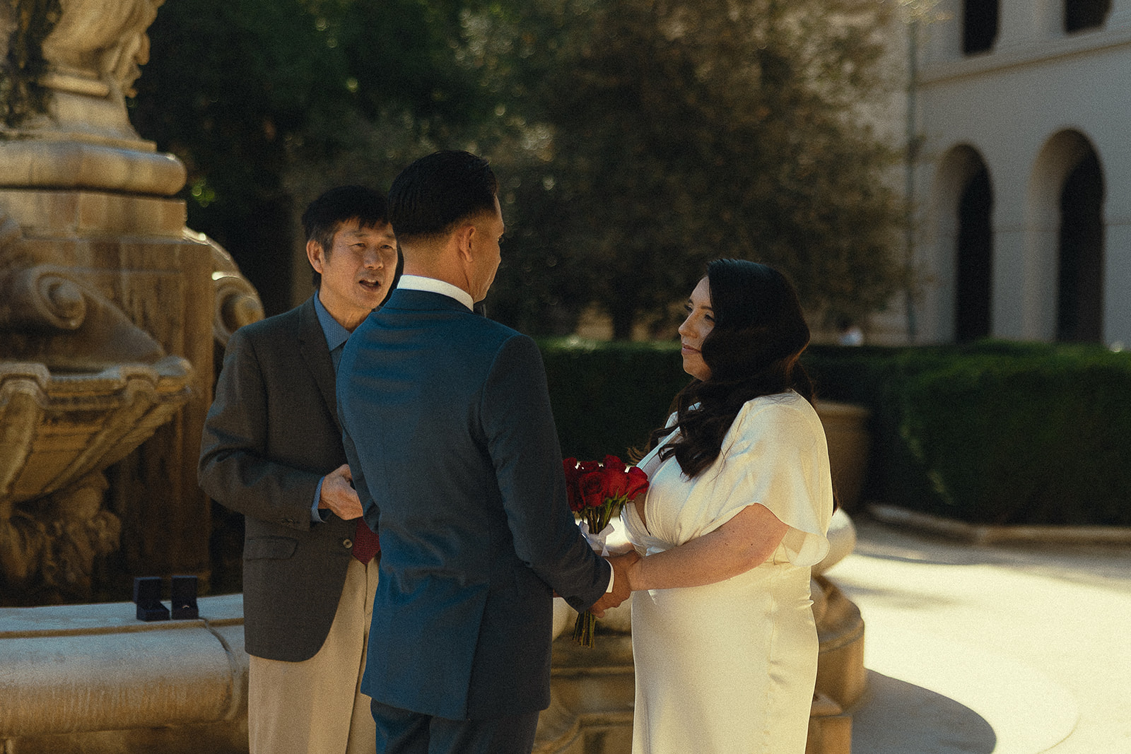 Couple holding hands and smiling during their Pasadena City Hall elopement.