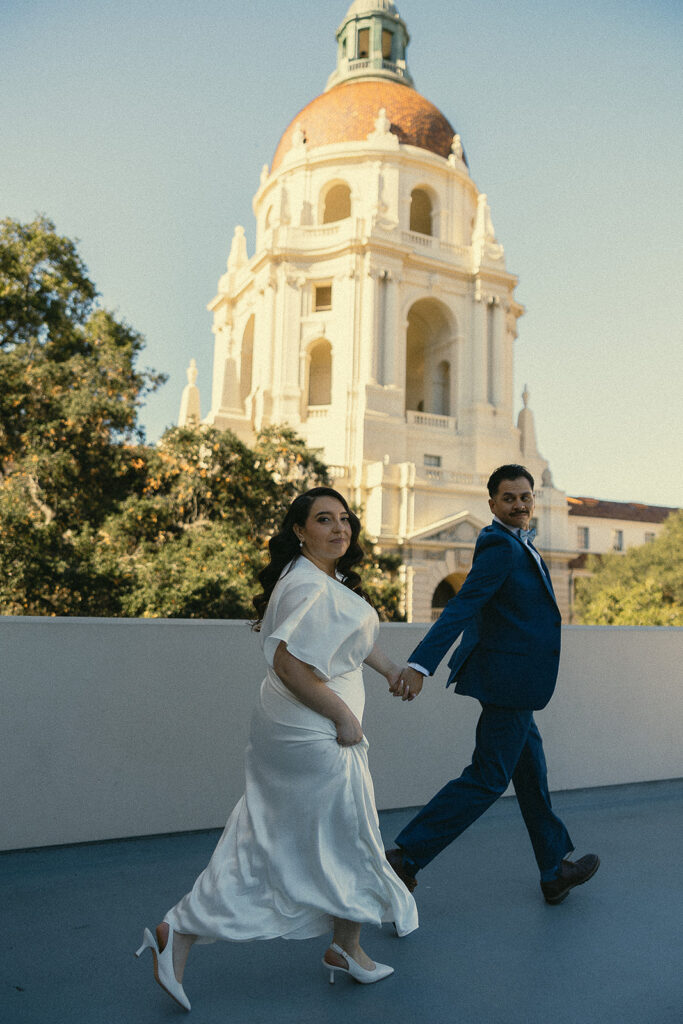 Couple running outside for their elopement photos.