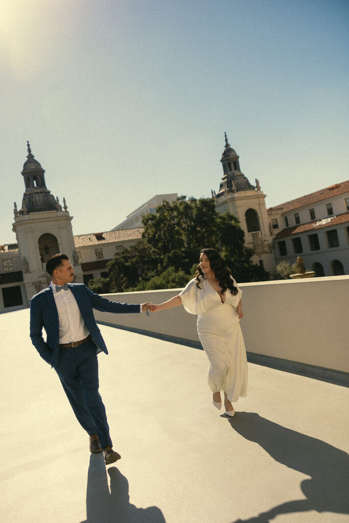 Couple running outside for their elopement photos.