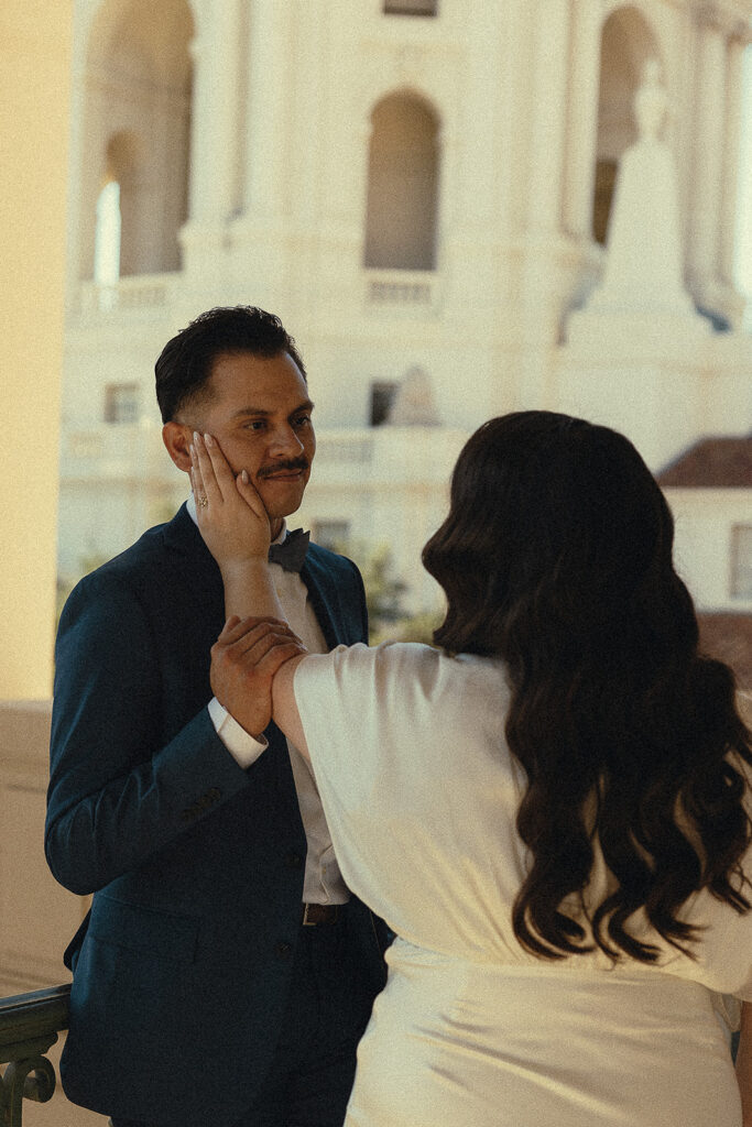 Woman caressing the grooms face. 