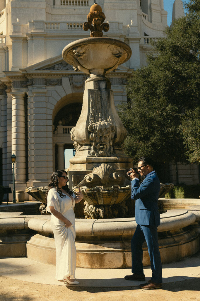 Groom taking a photo of the bride.
