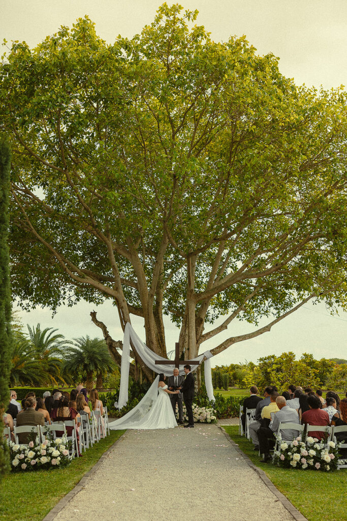 A far away shot of a Cinco Farm Gardens Miami wedding ceremony.