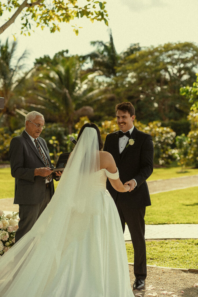 Bride and groom holding hands for their Cinco Farm Gardens Miami wedding ceremony.