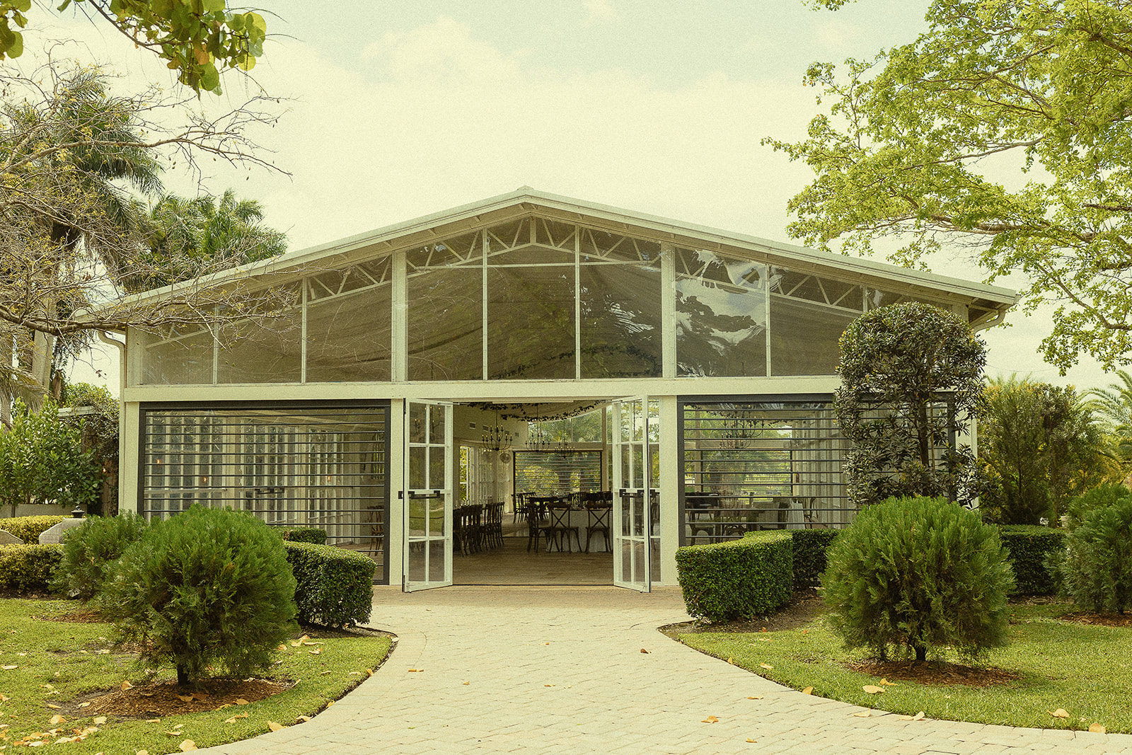 Exterior shot of the glass open-air pavilion for a Cinco Farm Gardens wedding reception in Miami, Florida.