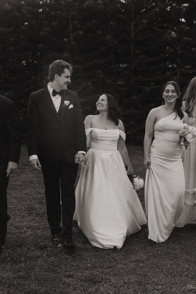 Black and white wedding party photo outdoors..