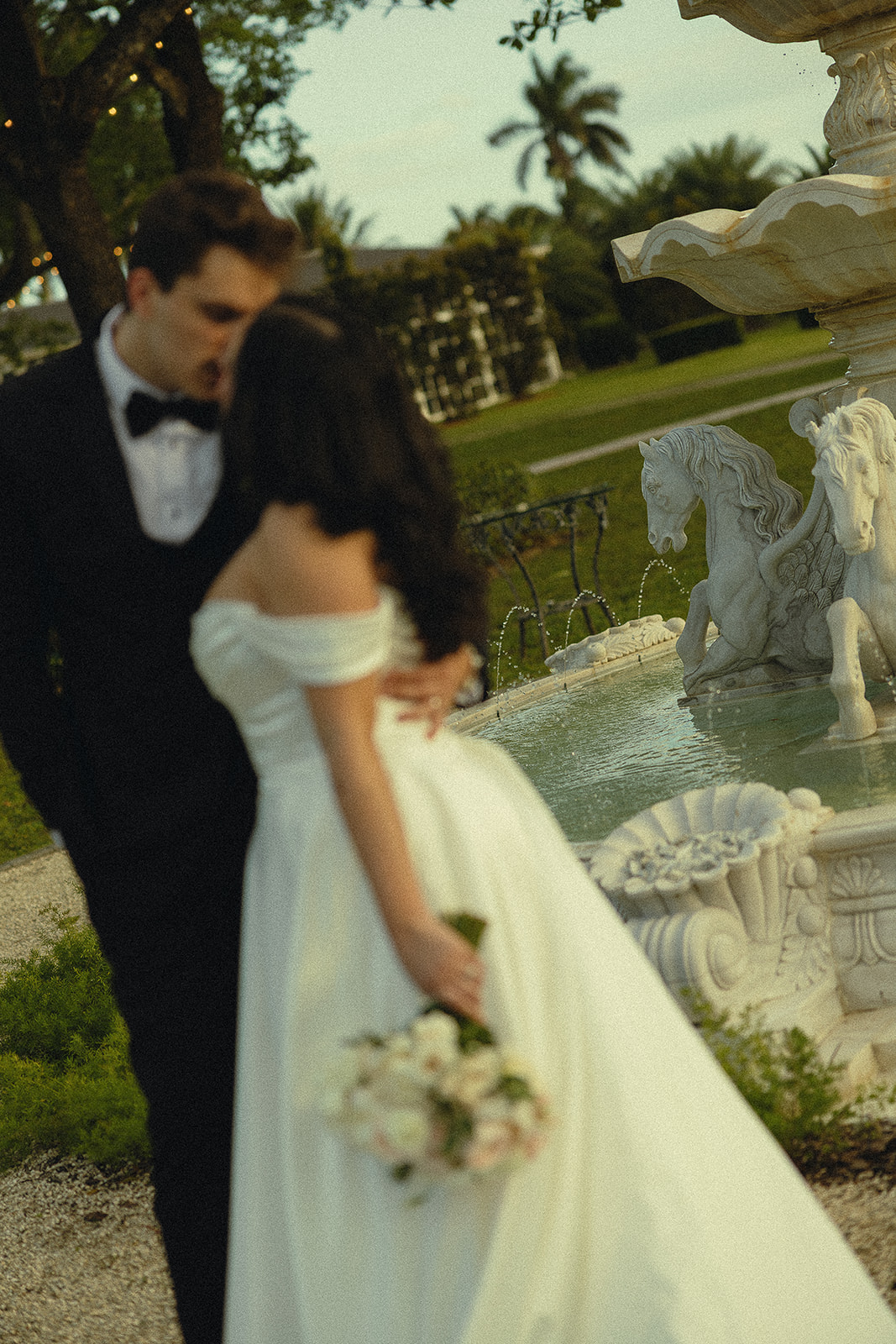 Bride and groom near fountain during Miami wedding portraits.