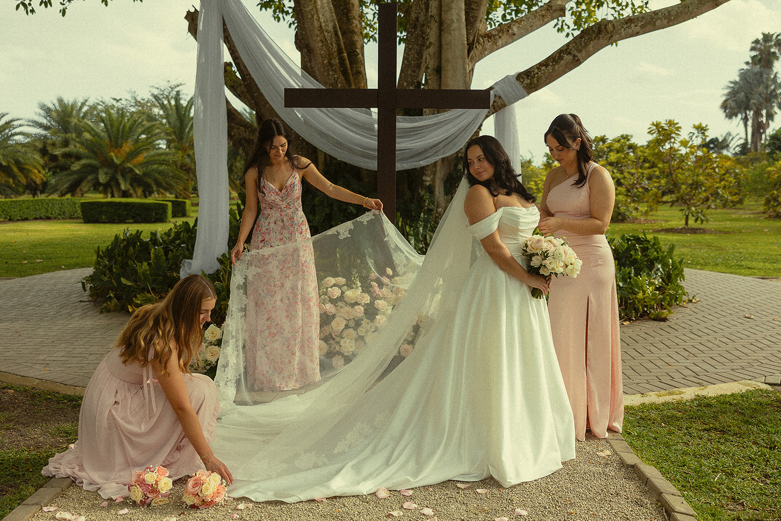 Bride and bridesmaids in pink dresses at Miami wedding venue.