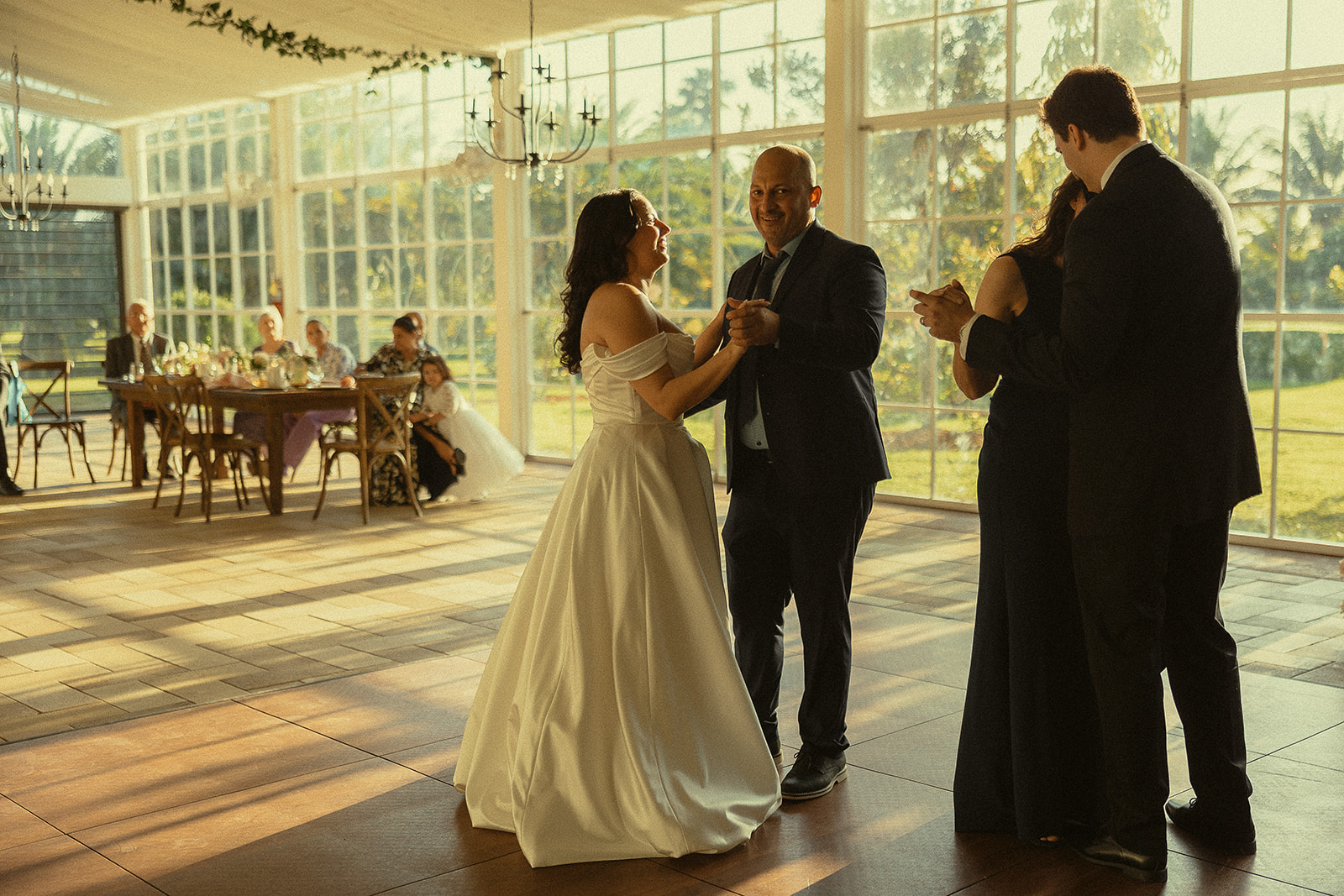 Bride dancing with her father and groom dancing with his mother during Miami wedding reception.