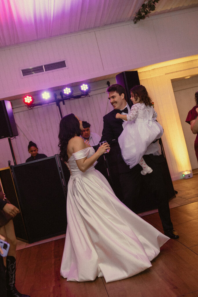 Bride and groom smiling together on the dance floor.