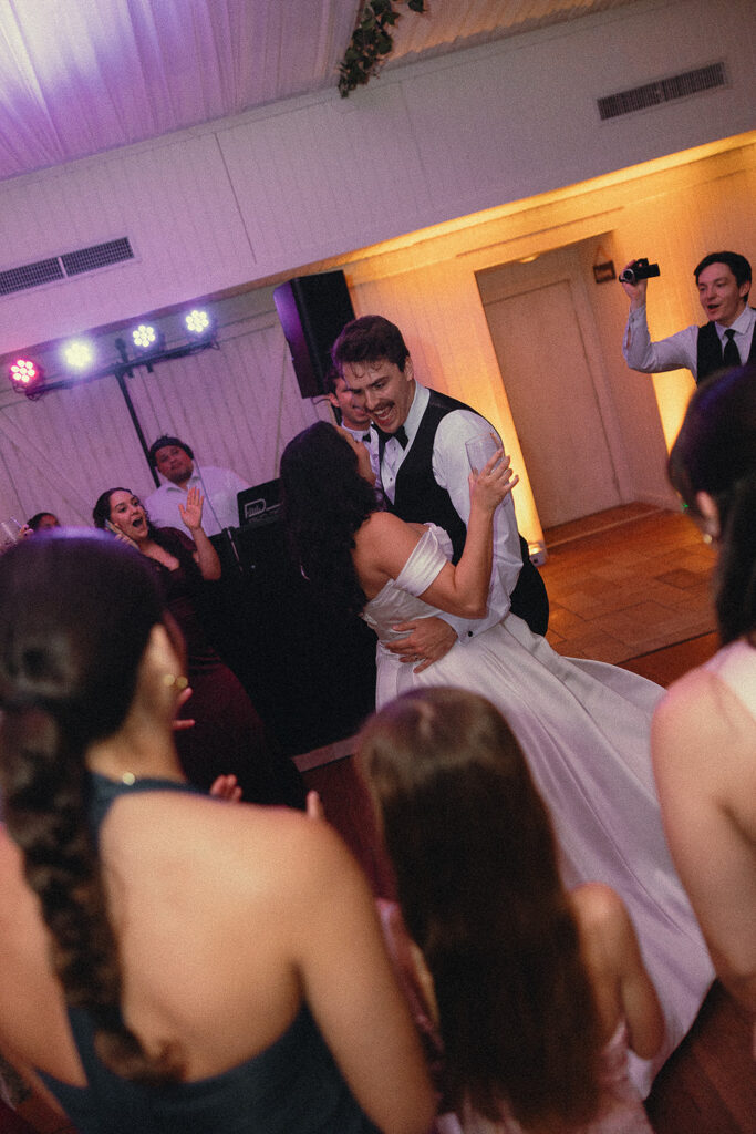 Bride and groom smiling together on the dance floor
