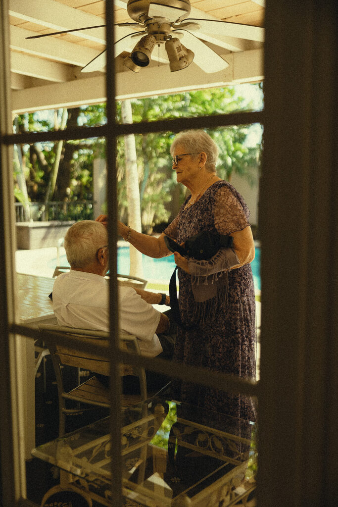 Documentary style wedding photo of family members getting ready.