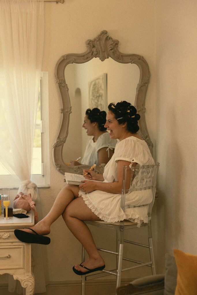 Bride writing in a notebook before her Miami wedding.