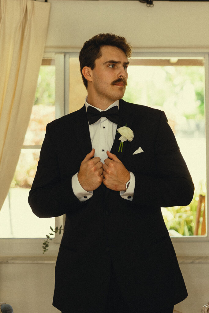 Indoor grooms portraits from a Miami wedding.
