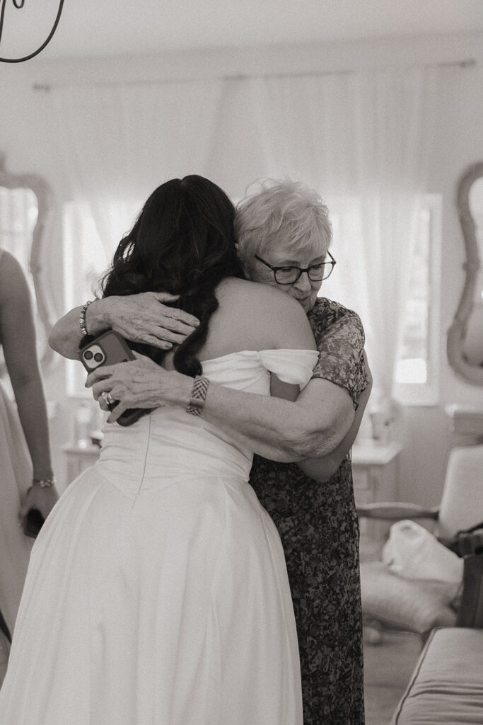 Bride hugging her grandmother before her Miami wedding.
