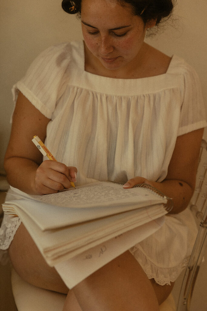 Bride writing in a notebook before her Miami wedding.