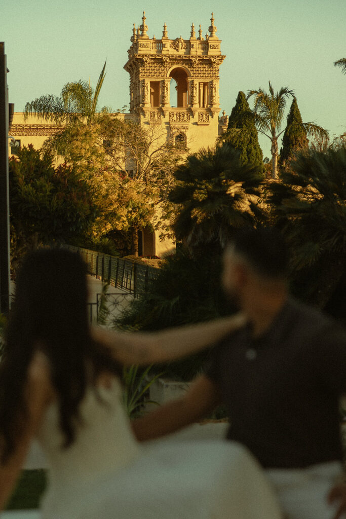 Couples admiring the architectural details of Balboa Park during a San Diego engagement session.