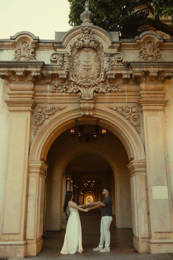 Couple holing hands in a beautiful archway
