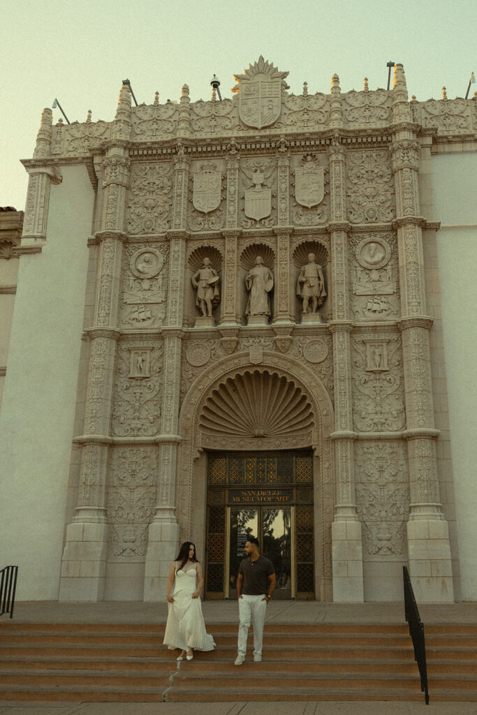 Couple posing outside the Museum of Us during Balboa Park engagement photos in San Diego.