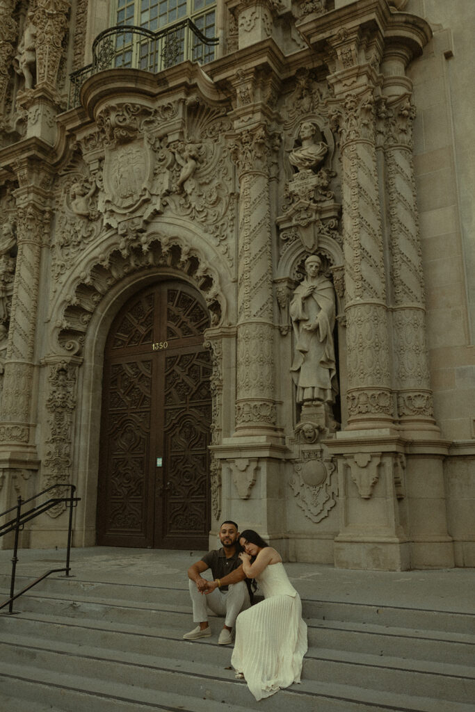 Couple sitting on the Museum of Us steps.