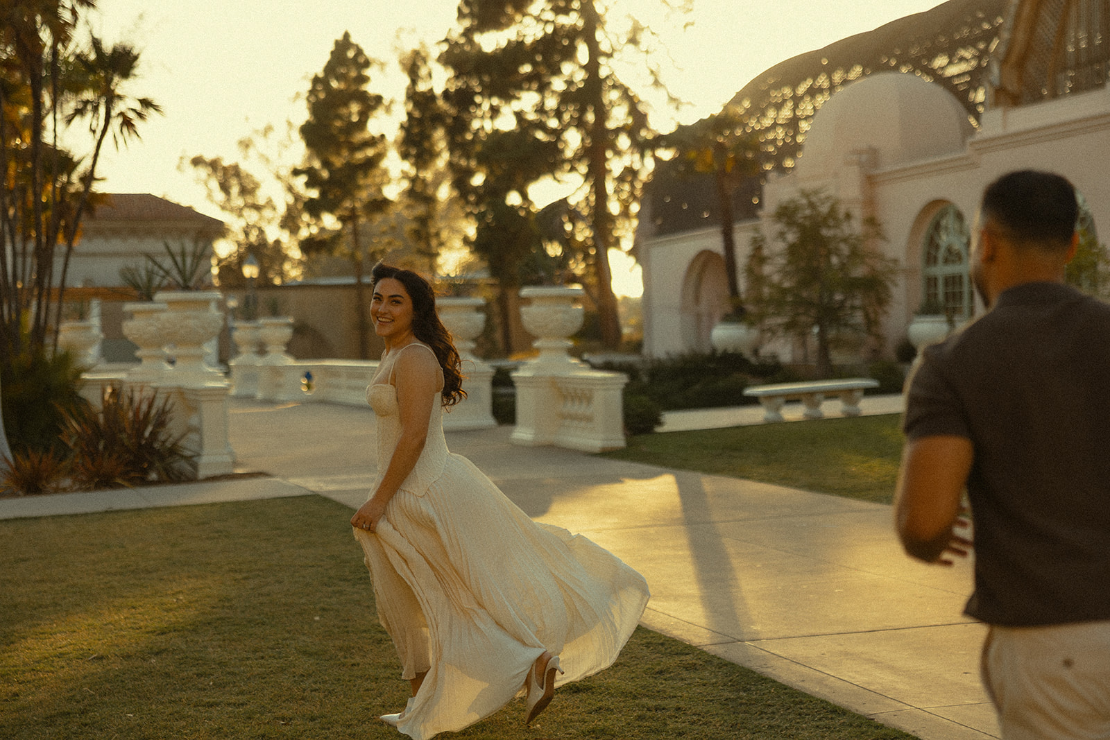 Couple walking near the Botanical Building during golden hour at Balboa Park.