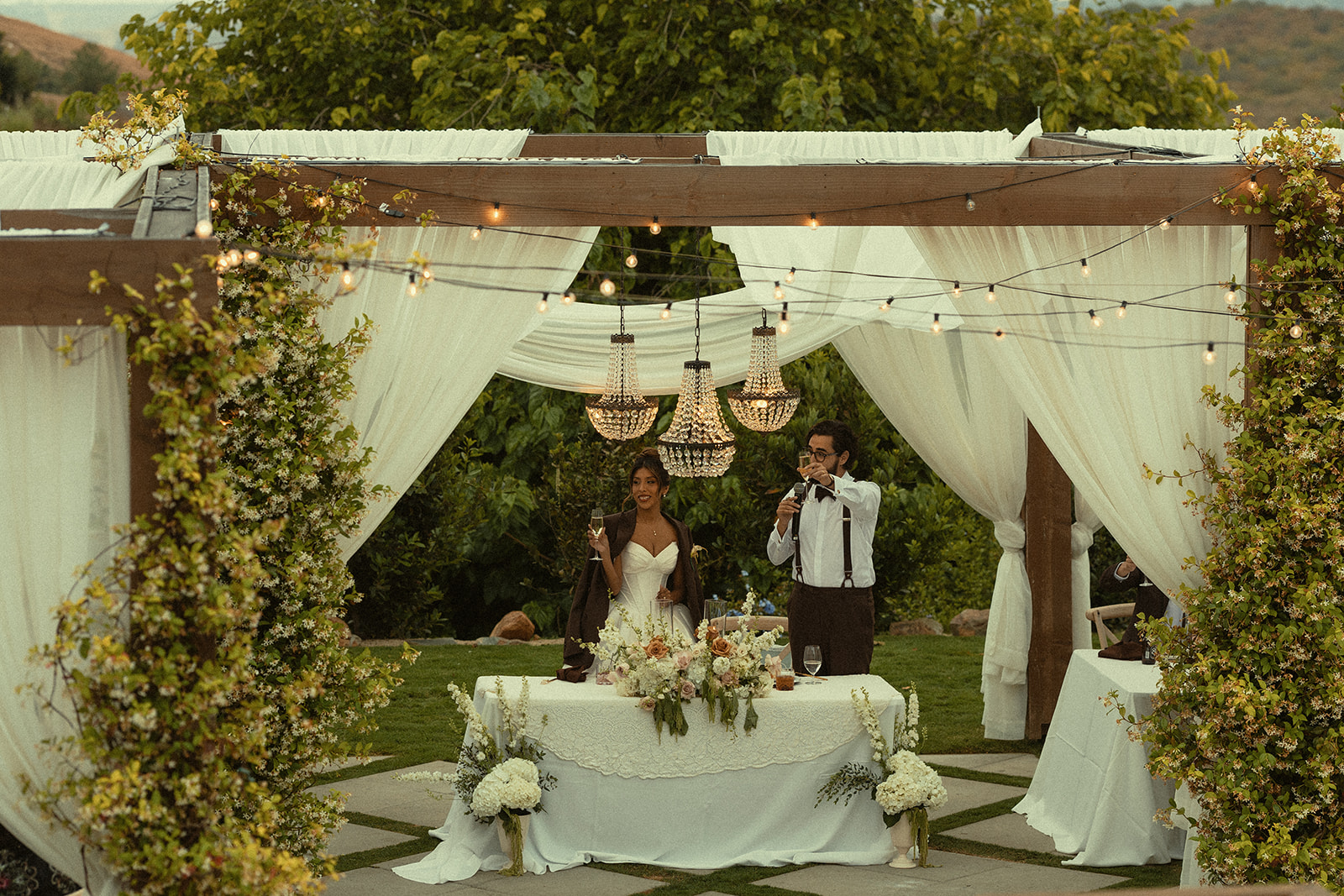 Bride and groom toasting their drinks during speeches.