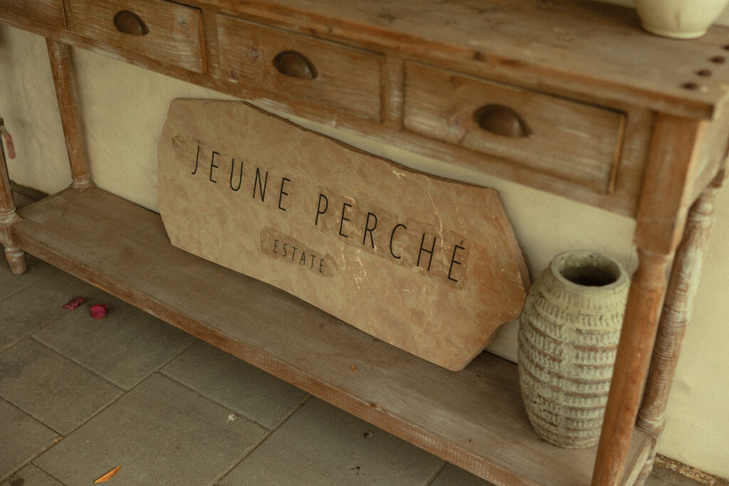 Wooden sign that says Juene Perche Estate.