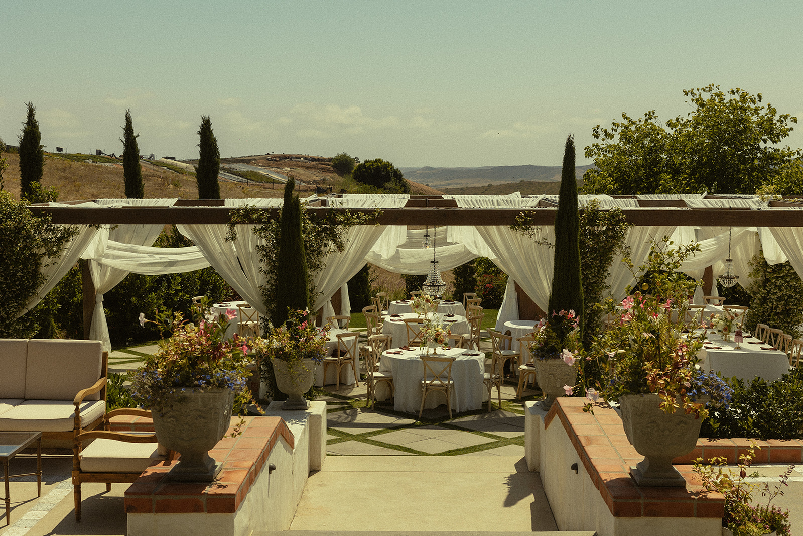 Wide shot of a reception setup under the Pergola at Jeune Perché.