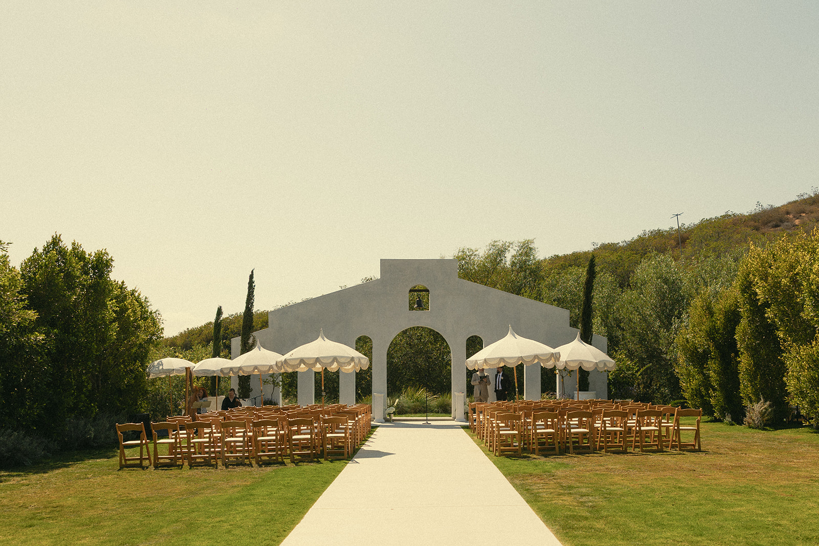 An outdoor garden wedding ceremony setup at Jeune Perché.