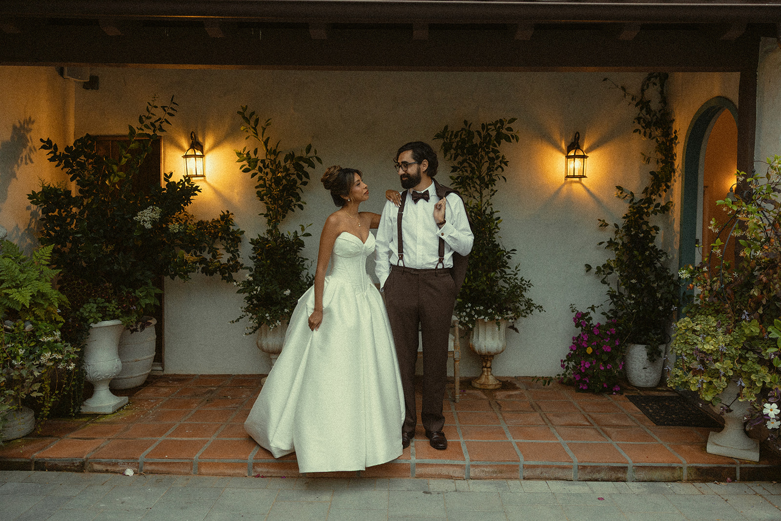 Bride and groom posing outside of Jeune Perché.