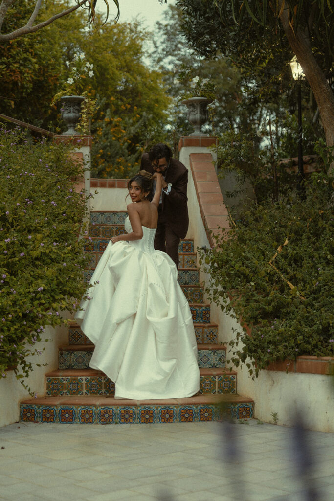 Bride and groom walking up outdoor steps at Jeune Perché.